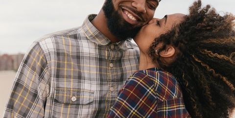 romantic-young-couple-kissing-on-beach-high-res-stock-photography-536992349-1533248632
